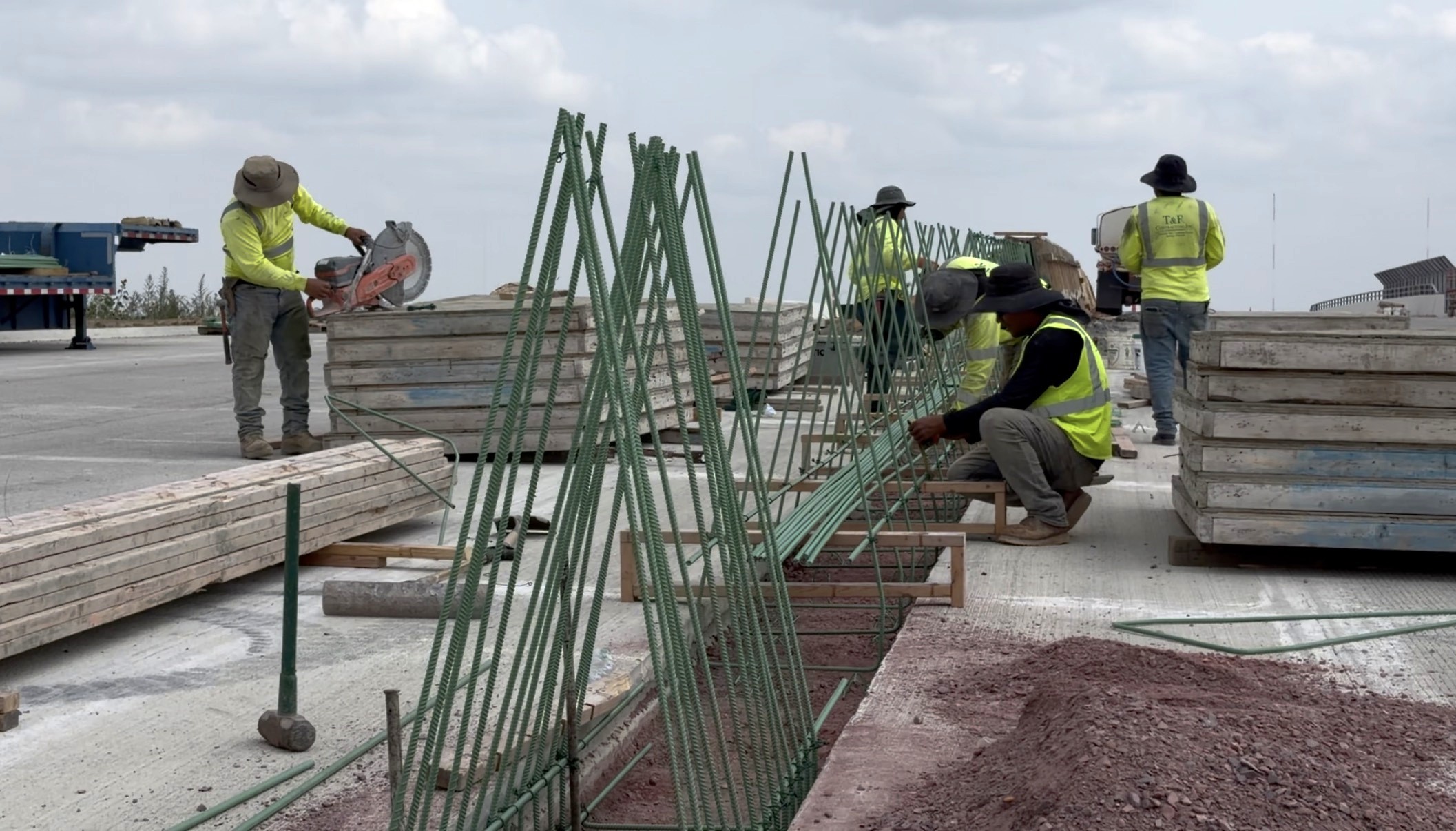 Construction crews installing barrier walls for the approach to the BNSF bridge overpass.