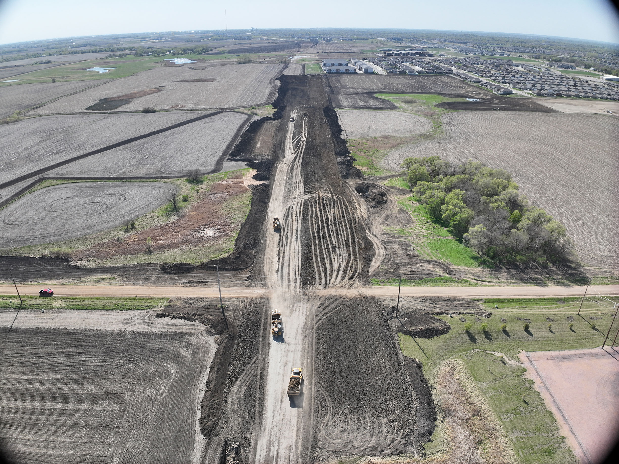 Aerial view of dirt tracks from construction equipment.